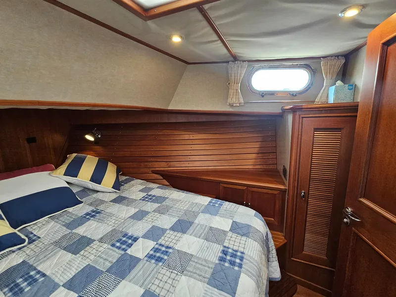 Slide: The Image of Cozy cabin interior of 2007 Grand Banks 39 Eastbay SX with wood paneling and bed. - 24