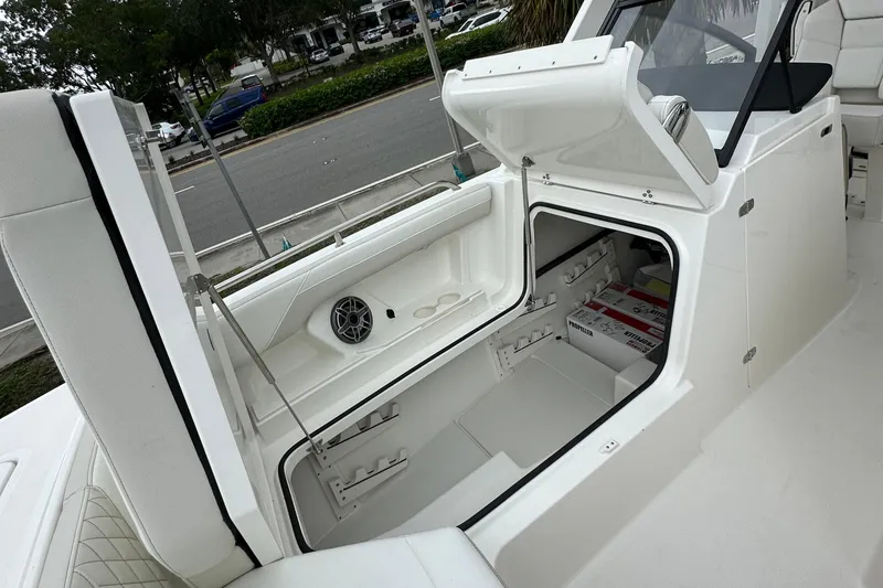 Slide: The Image of 2025 World Cat 260 DC-X boat interior storage compartment with open hatch. - 11