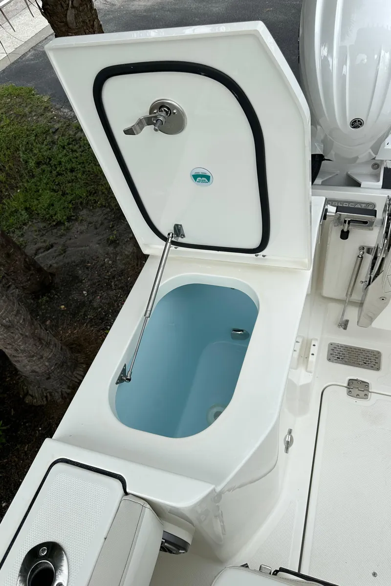 Slide: The Image of 2025 World Cat 260 DC-X boat livewell with open lid, showcasing interior design. - 15