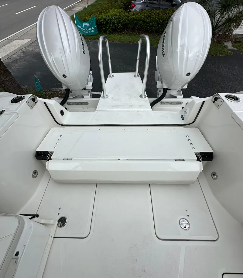 Slide: The Image of 2025 World Cat 260 DC-X boat with dual outboard motors, rear deck view. - 16