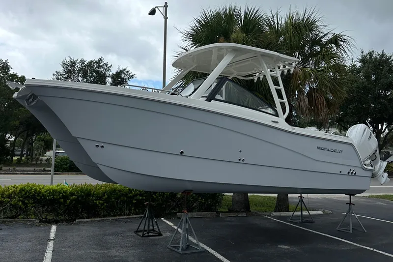 Slide: The Image of 2025 World Cat 260 DC-X boat on display in a parking lot. - 19