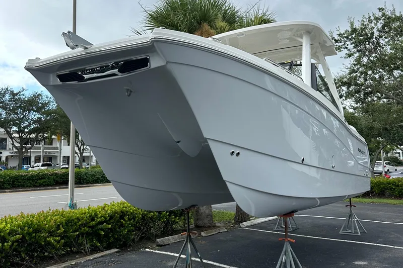 Slide: The Image of 2025 World Cat 260 DC-X boat on display, elevated on stands. - 2