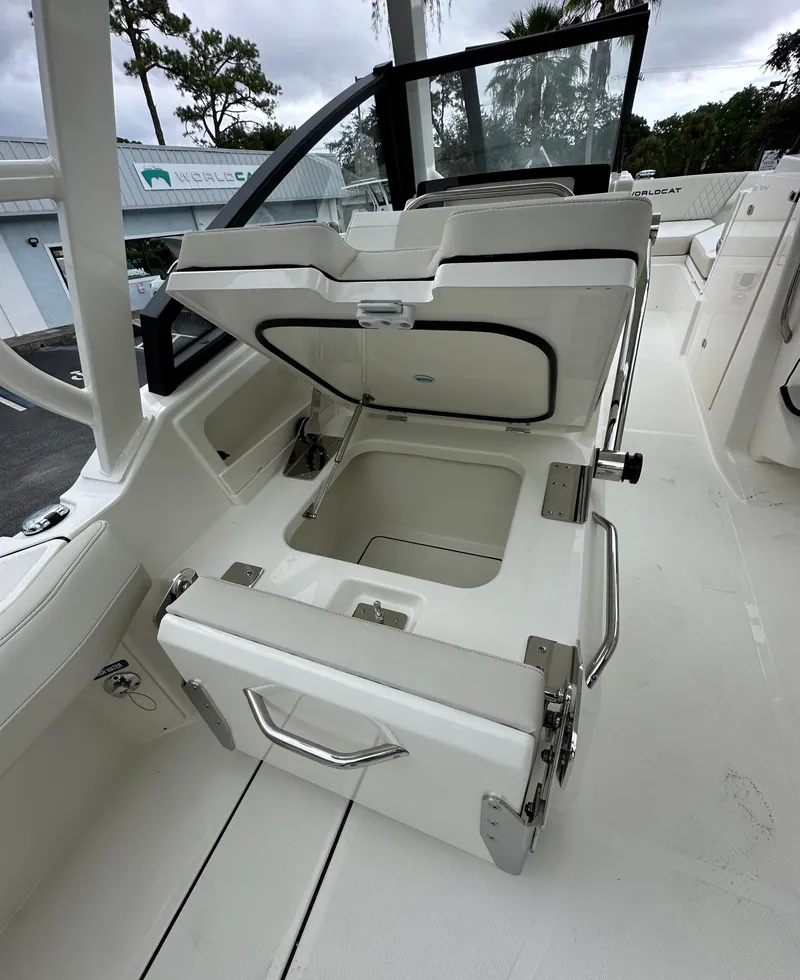 Slide: The Image of 2025 World Cat 260 DC-X boat with open storage compartment on deck. - 7