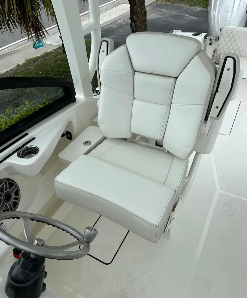 Slide: The Image of 2025 World Cat 260 DC-X boat interior with white captain's chair and steering wheel. - 8
