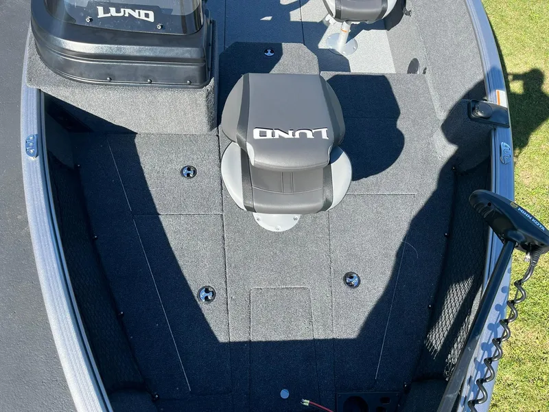Slide: The Image of 2025 Lund 1775 Impact XS SS boat interior with seating and carpeted deck. - 11
