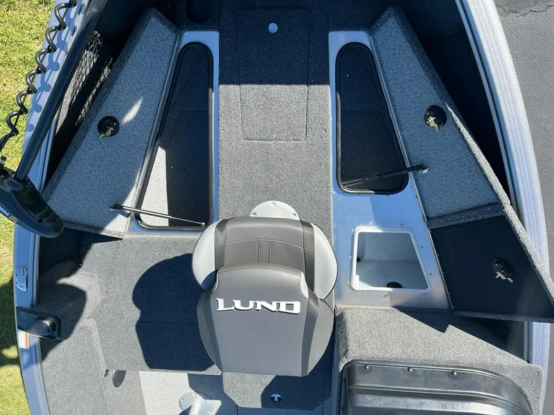 Slide: The Image of 2025 Lund 1775 Impact XS SS boat interior with seating and storage compartments. - 12
