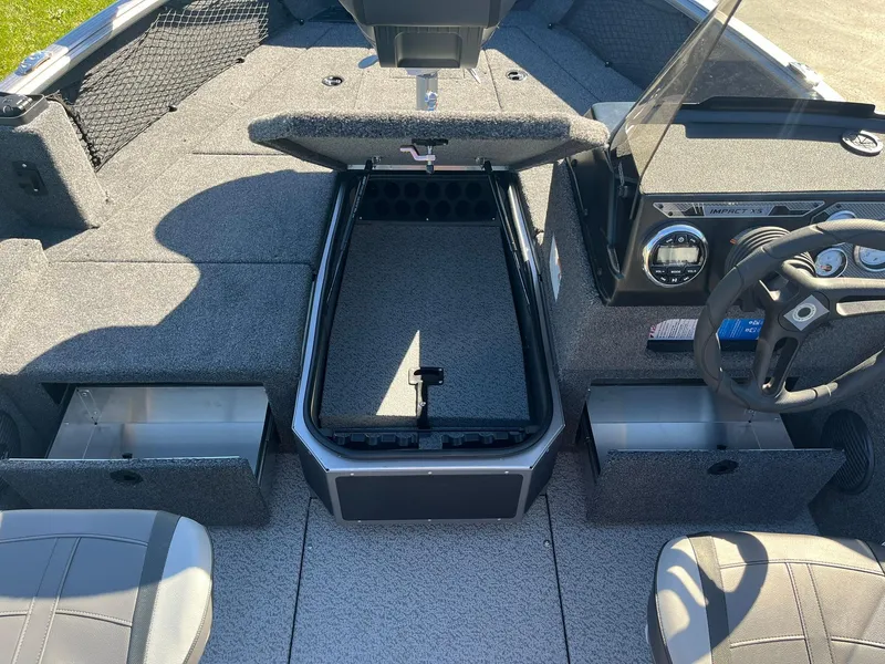 Slide: The Image of 2025 Lund 1775 Impact XS SS boat interior with open storage compartments. - 14