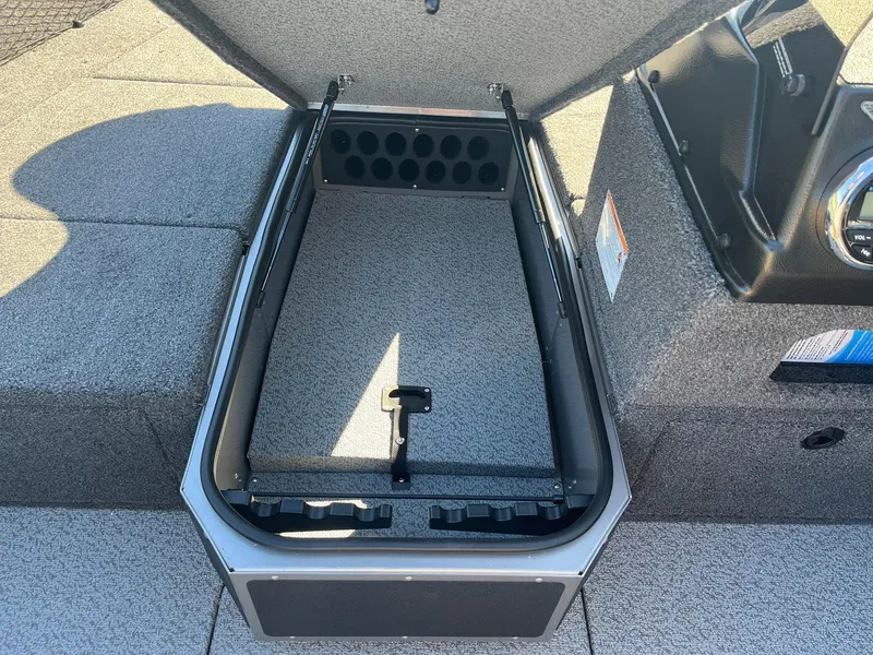 Slide: The Image of 2025 Lund 1775 Impact XS SS boat storage compartment with rod holders. - 15