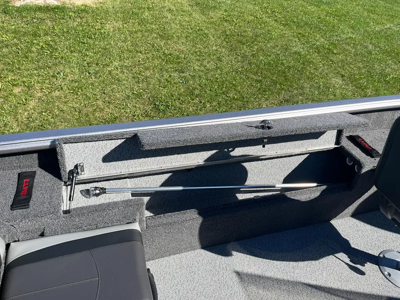Slide: The Image of 2025 Lund 1775 Impact XS SS boat interior with storage compartment and seating. - 21