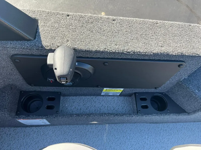 Slide: The Image of 2025 Lund 1775 Impact XS SS boat interior detail with control panel and cup holders. - 24