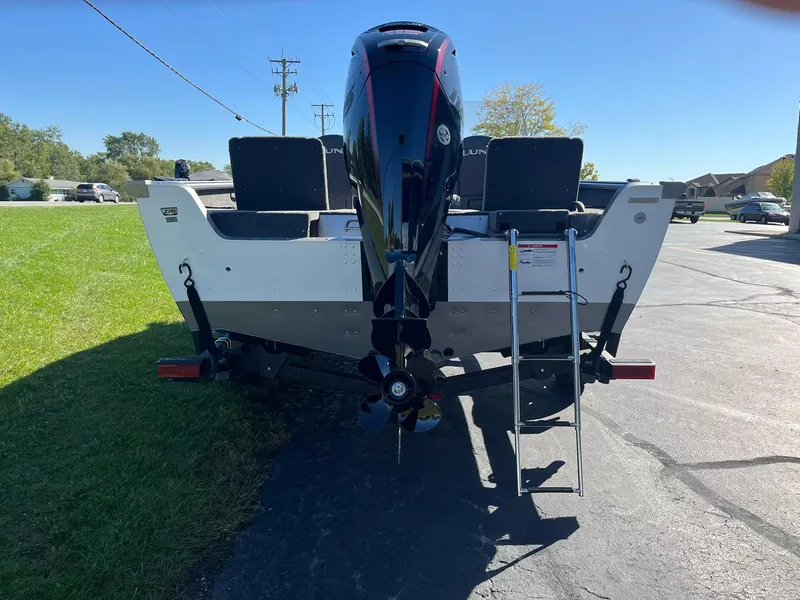 Slide: The Image of 2025 Lund 1775 Impact XS SS boat rear view with motor and ladder. - 25