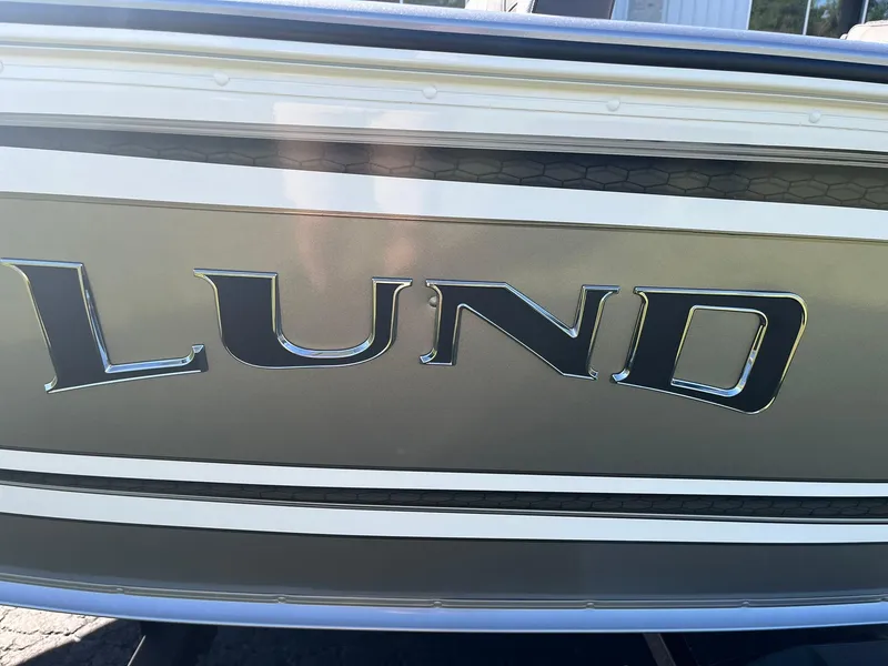 Slide: The Image of 2025 Lund 1775 Impact XS SS boat logo on metallic exterior. - 26