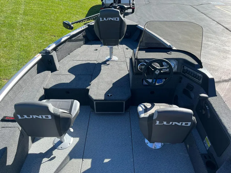 Slide: The Image of 2025 Lund 1775 Impact XS SS boat interior with seating and steering console. - 3