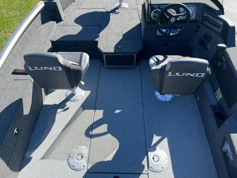 Slide: The Image of 2025 Lund 1775 Impact XS SS boat interior with two seats and steering console. - 4