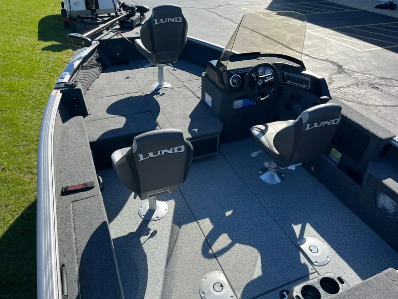 Slide: The Image of 2025 Lund 1775 Impact XS SS boat interior with seating and steering console. - 5