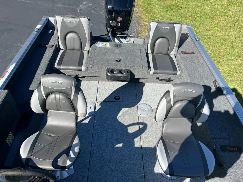 Slide: The Image of 2025 Lund 1775 Impact XS SS boat interior with four gray seats. - 9