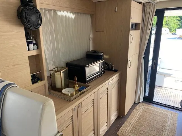 Slide: The Image of Interior of 2022 Beneteau Swift Trawler 41 Fly with modern kitchen amenities. - 10