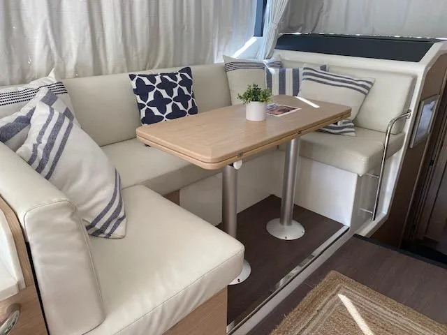Slide: The Image of Interior of 2022 Beneteau Swift Trawler 41 Fly with cozy seating and table. - 12