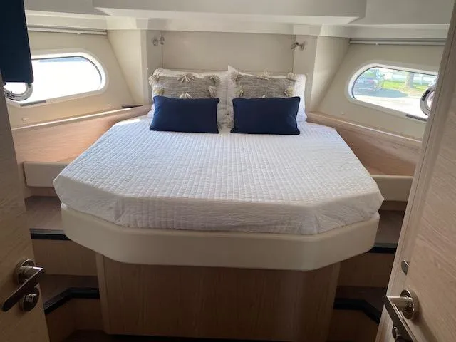 Slide: The Image of Luxurious bedroom in 2022 Beneteau Swift Trawler 41 Fly yacht with elegant bedding. - 14
