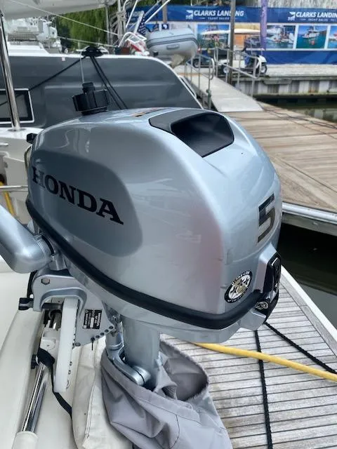 Slide: The Image of Honda 5HP outboard motor on 2022 Beneteau Swift Trawler 41 Fly at marina. - 20