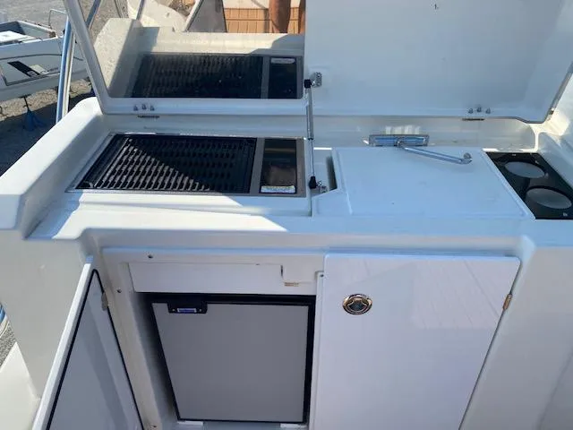 Slide: The Image of Outdoor kitchen on 2022 Beneteau Swift Trawler 41 Fly with grill and mini fridge. - 7