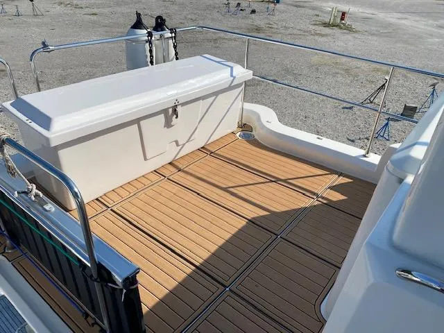 Slide: The Image of Beneteau Swift Trawler 41 Fly 2022 deck with wooden flooring and storage box. - 8