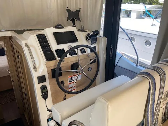 Slide: The Image of Interior helm of 2022 Beneteau Swift Trawler 41 Fly with modern controls. - 9