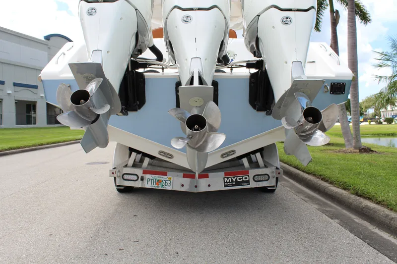 Slide: The Image of 2015 Cigarette 39 GTS boat with triple outboard engines on trailer. - 17