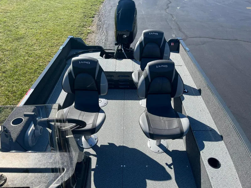 Slide: The Image of 2025 Lund 1650 Angler SS boat interior with two seats and steering console. - 10