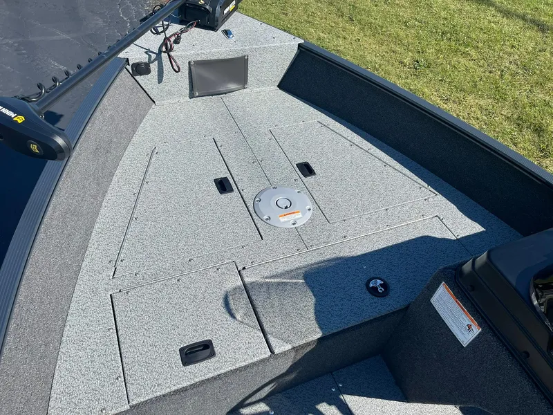 Slide: The Image of 2025 Lund 1650 Angler SS boat deck with storage compartments and fishing features. - 11