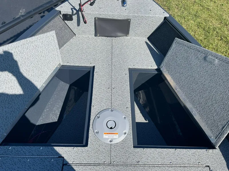 Slide: The Image of 2025 Lund 1650 Angler SS boat interior with open storage compartments. - 13