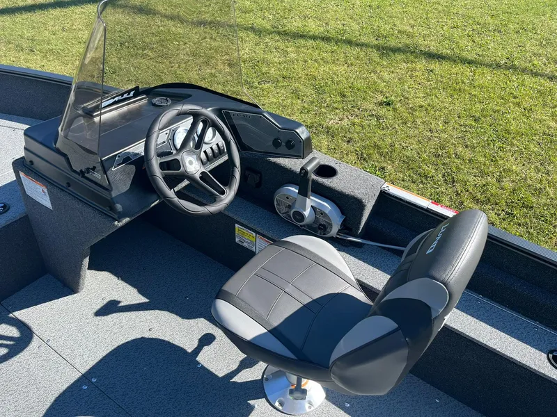 Slide: The Image of 2025 Lund 1650 Angler SS boat interior with steering wheel and seat. - 14