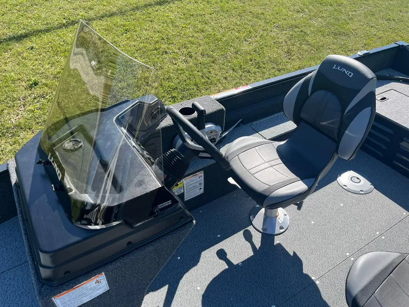 Slide: The Image of 2025 Lund 1650 Angler SS boat interior with steering console and cushioned seat. - 17
