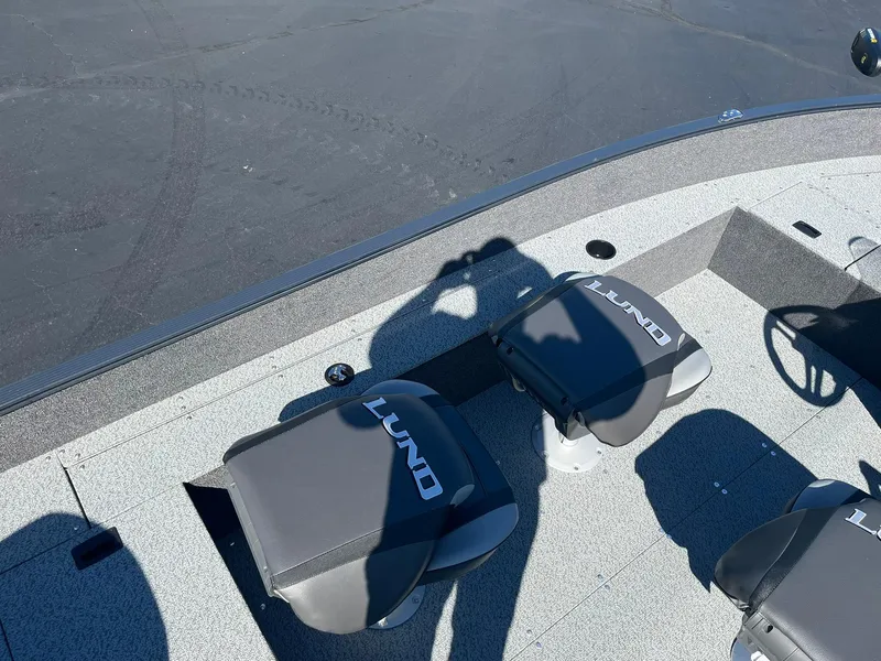 Slide: The Image of 2025 Lund 1650 Angler SS boat seats with shadow on deck. - 19