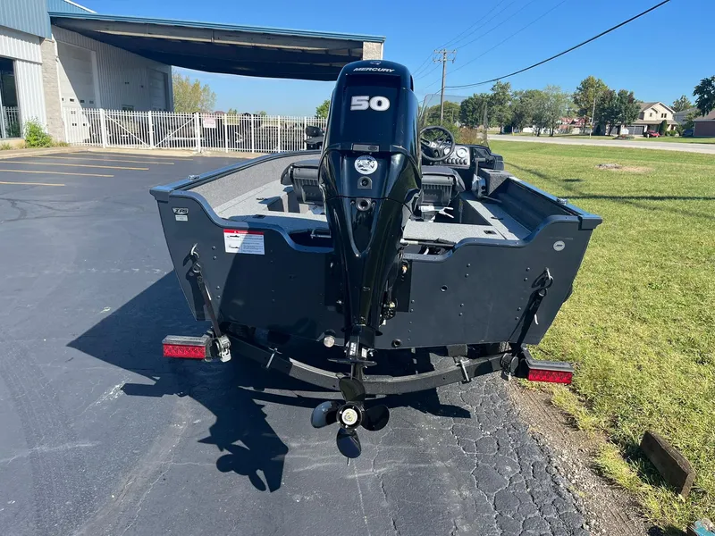 Slide: The Image of 2025 Lund 1650 Angler SS boat with 50 HP motor, parked outdoors. - 20
