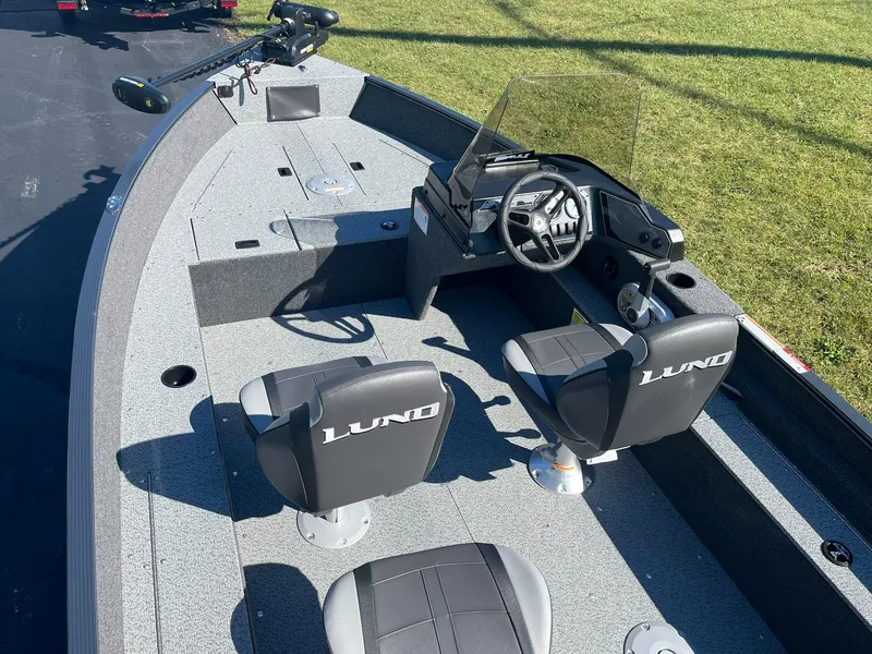 Slide: The Image of 2025 Lund 1650 Angler SS fishing boat interior with steering console and seating. - 5
