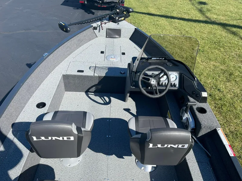 Slide: The Image of 2025 Lund 1650 Angler SS boat interior with steering wheel and seating. - 6