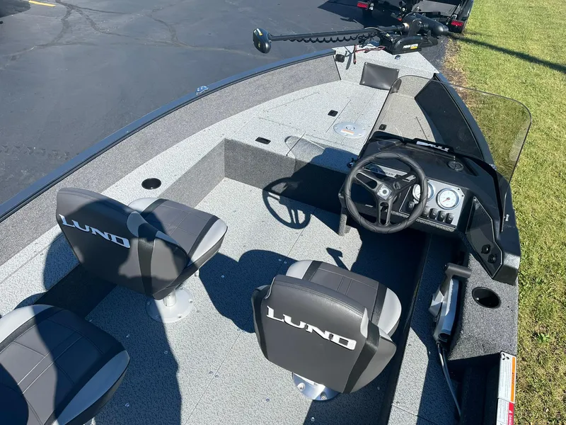 Slide: The Image of 2025 Lund 1650 Angler SS boat interior with steering console and seating. - 7