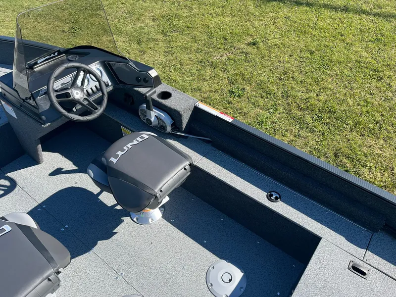 Slide: The Image of 2025 Lund 1650 Angler SS boat interior with steering wheel and seating. - 8