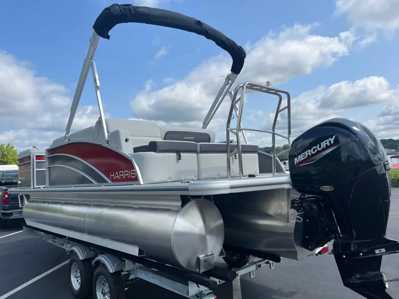Slide: The Image of 2025 Harris Cruiser 210 pontoon boat with Mercury outboard motor on trailer. - 3