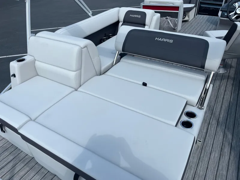 Slide: The Image of 2025 Harris Cruiser 210 boat with white and gray seating. - 6