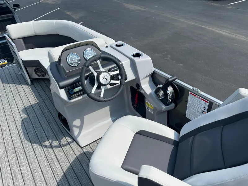Slide: The Image of 2025 Harris Cruiser 210 boat interior with steering wheel and seating. - 8