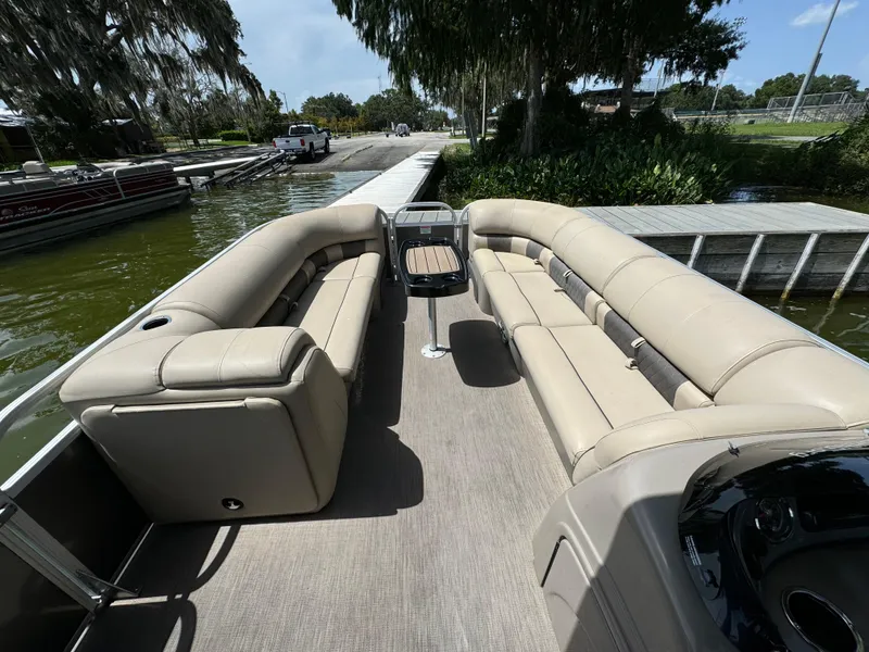 Slide: The Image of 2023 Sun Tracker Party Barge 24 DLX pontoon boat with spacious seating at dock. - 10