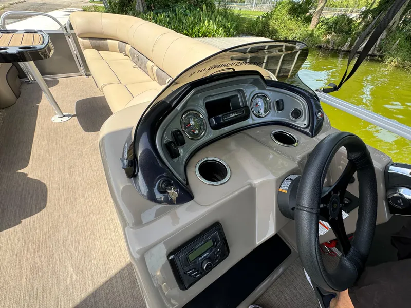 Slide: The Image of 2023 Sun Tracker Party Barge 24 DLX interior with steering console and seating. - 11