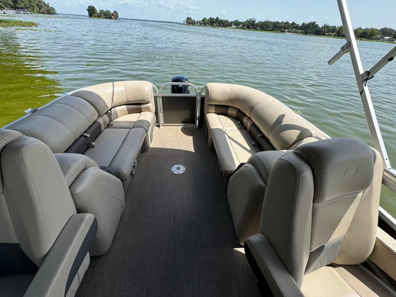 Slide: The Image of 2023 Sun Tracker Party Barge 24 DLX pontoon boat interior on a lake. - 12
