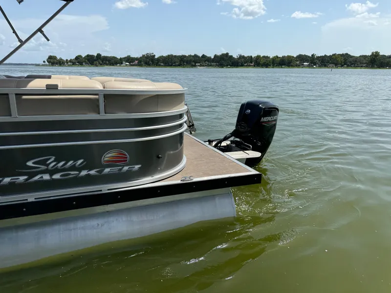 Slide: The Image of 2023 Sun Tracker Party Barge 24 DLX pontoon boat on a lake with Mercury outboard motor. - 3