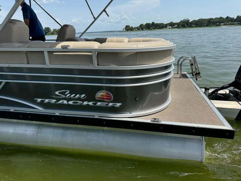 Slide: The Image of 2023 Sun Tracker Party Barge 24 DLX pontoon boat on a lake. - 4