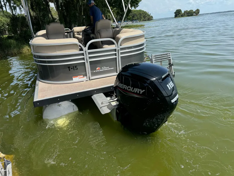 Slide: The Image of 2023 Sun Tracker Party Barge 24 DLX pontoon boat with Mercury 115 outboard motor on a lake. - 5