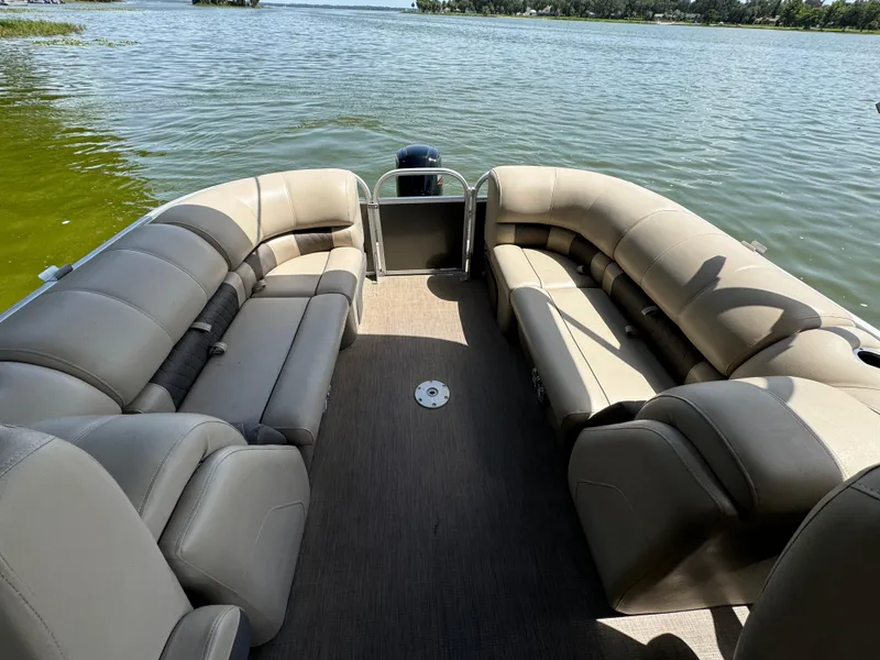 Slide: The Image of 2023 Sun Tracker Party Barge 24 DLX pontoon boat interior on a lake. - 8