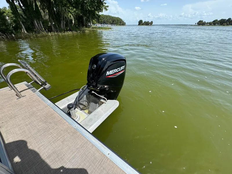 Slide: The Image of 2023 Sun Tracker Party Barge 24 DLX with Mercury outboard motor on a lake. - 9